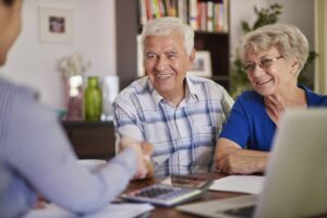 a couple in their golden years sitting down with a financial planner to do retirement planning